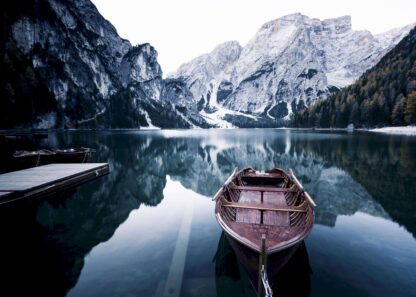 Wooden boat at alpine lake poster