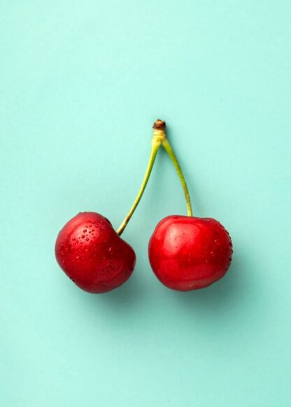 Cherry couple on blue background poster