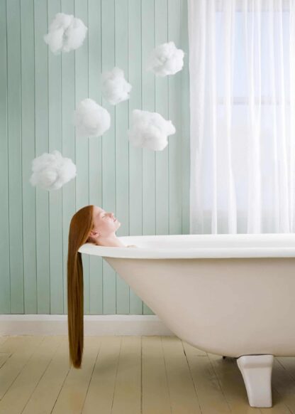 A girl with long hair relaxing in the bath poster